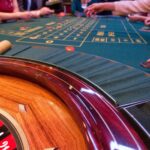 Roulette table with people placing bets
