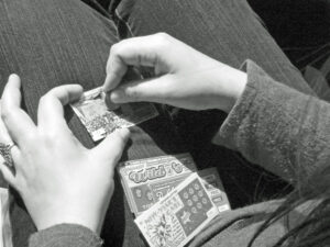 person playing scratch cards